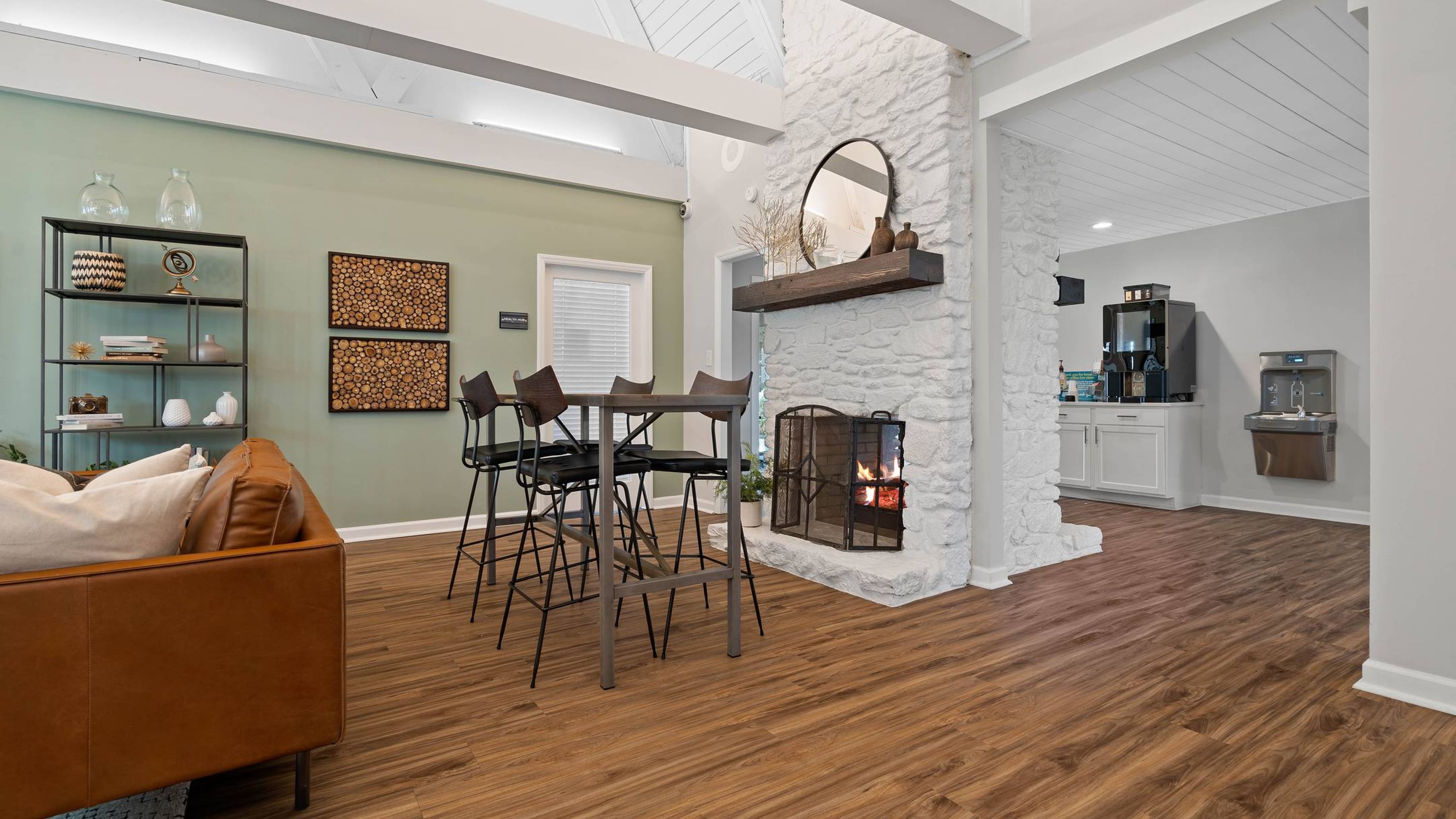 Hawthorne at Southside clubhouse lounge with vault ceiling, seating area, and large TV